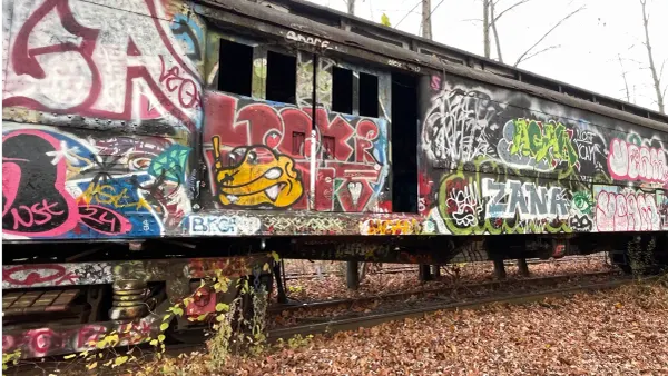 an old train car covered with spray paint art
