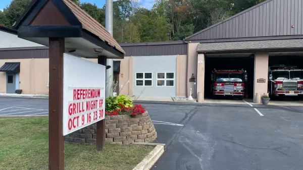 the facade of the fire department building with a sign advertising their upcoming grill nights