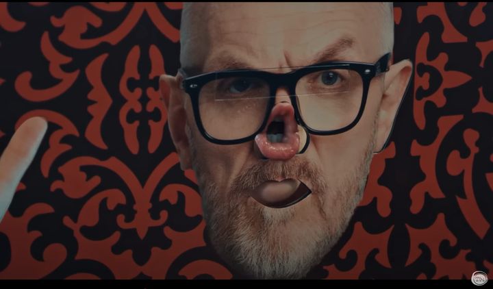 A cardboard cutout of Greg Davies, with an open mouth poking through the space where his nose should be.