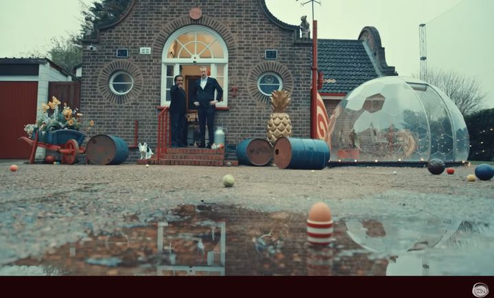 Sanjeev Bhaskar points out an egg in a striped egg cup to Little Alex Horne.