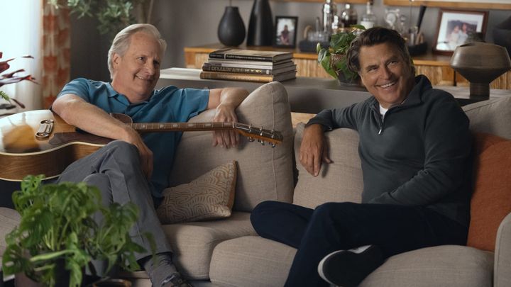 Jeff Daniels and Ted McGinley smile at something off-c