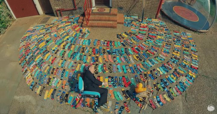 Armando Iannucci sits amid 472 socks