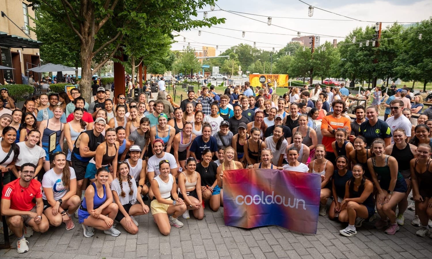 A large group or runners posing for a group photo outside