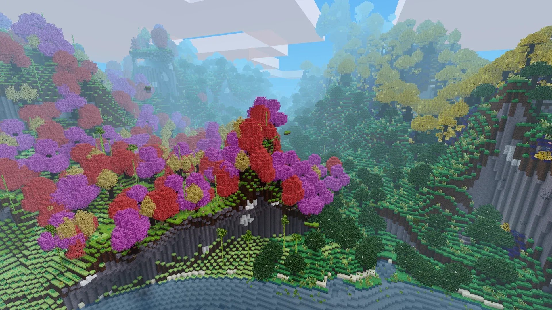 A bird's eye view of a forest where each tree's leaves are bright colors in pink, orange, and yellow. The forest borders mountains, the coast, and a more traditional green-leafed forest. 