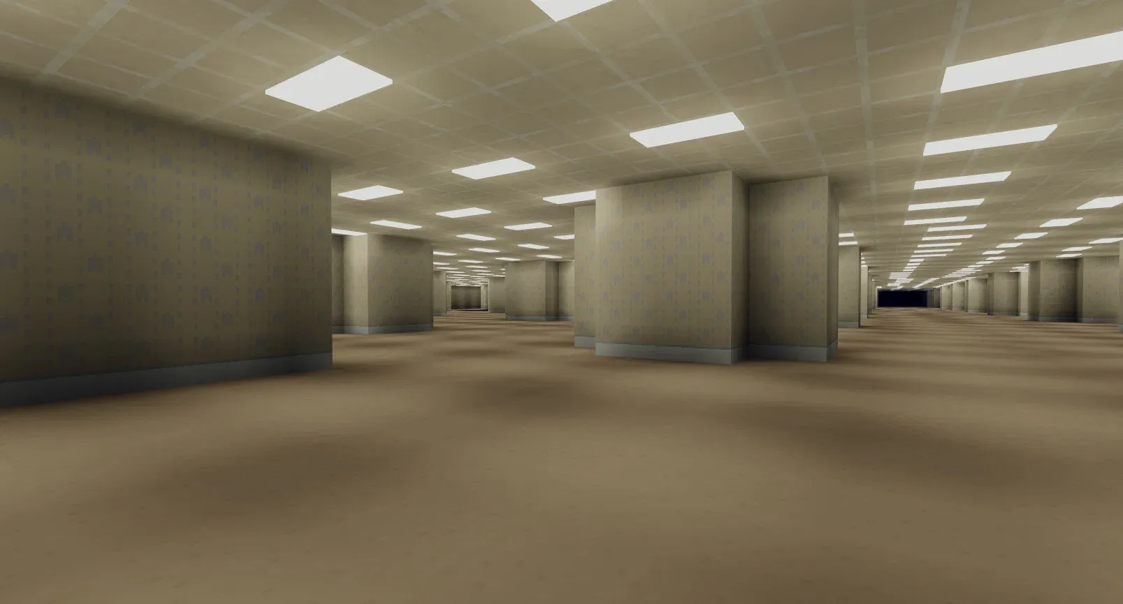 An endless floor of repeating walls like a massive floor of cubicles. The walls, carpet, and ceiling are all shades of yellow with a slight grey pattern on the walls showing an indistinct pattern of vertical lines and chevrons pointing upward.
