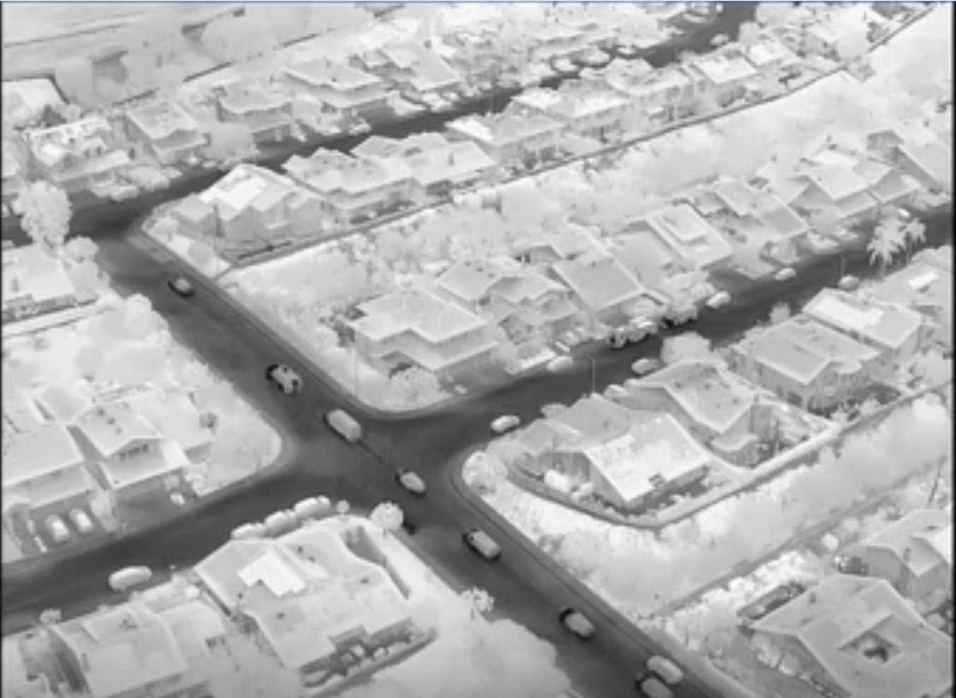 ICE drone footage shows a caravan of police driving in a suburban neighborhood in Irvine to serve an arrest warrant for posting a flier identifying ICE/DHS agents.