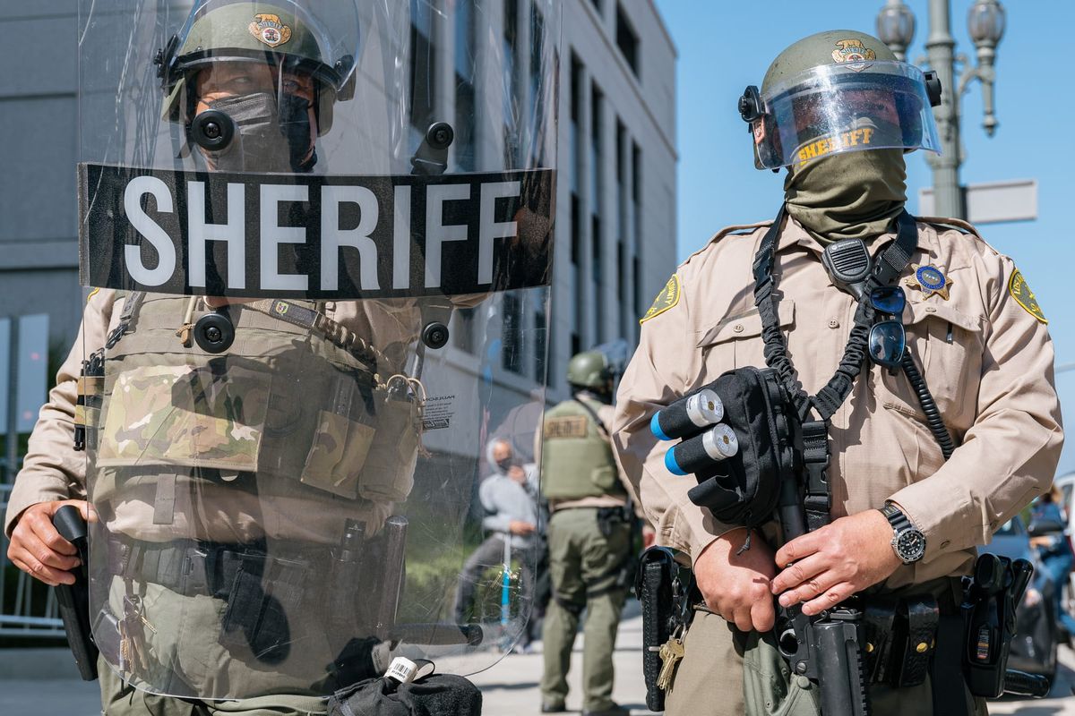 LASD deputies wearing riot gear in a skirmish line outside the Hall of Justice June 2021.