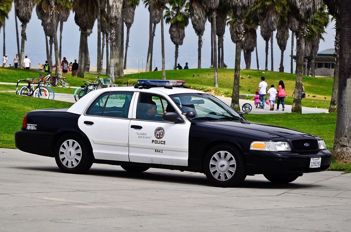 LAPD cruiser on a beach boardwalk. 