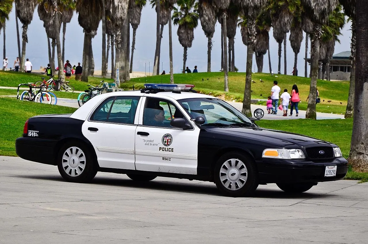 LAPD cruiser on a beach boardwalk. 