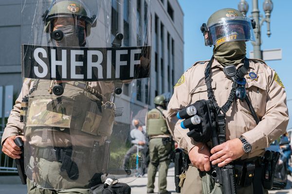 LASD deputies wearing riot gear in a skirmish line outside the Hall of Justice June 2021.
