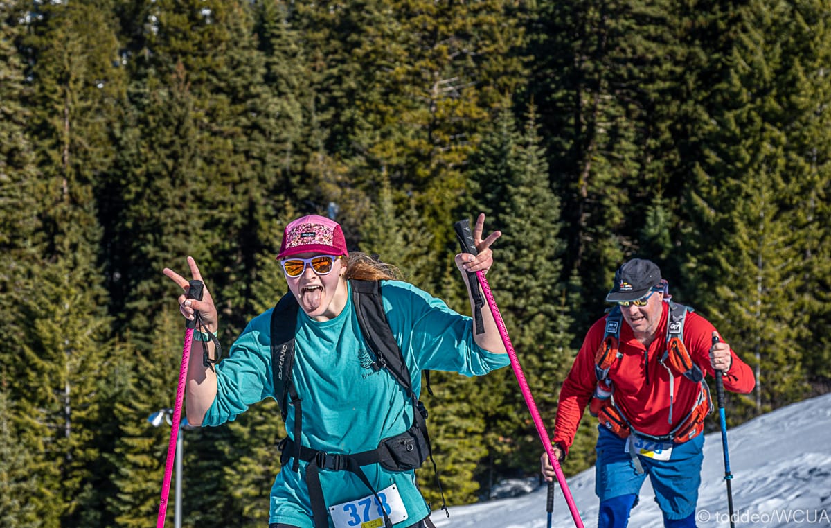 Two skiers touring up a mountain. 