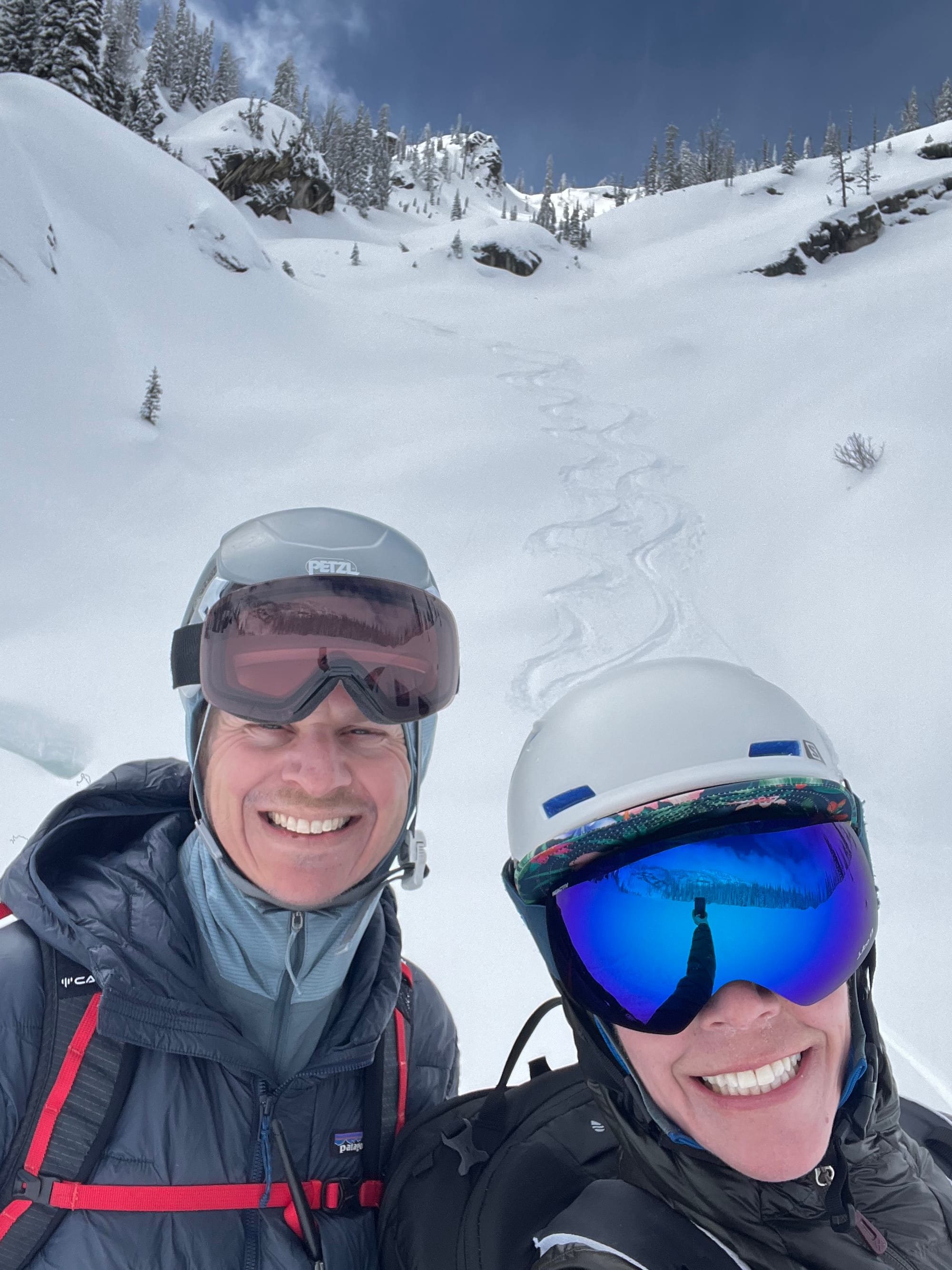 Picture of man and woman in front of their ski tracks. 