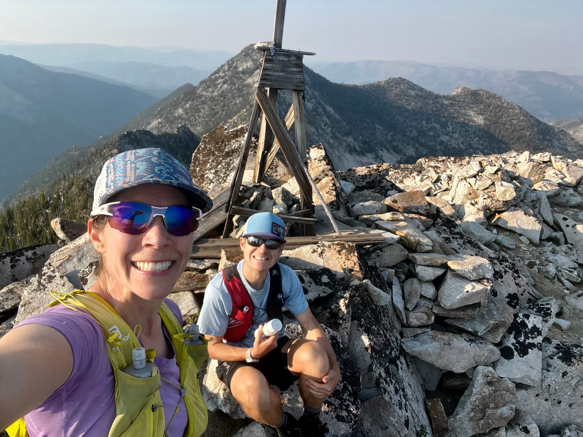 Picture of man and woman on top of rocky mountain.