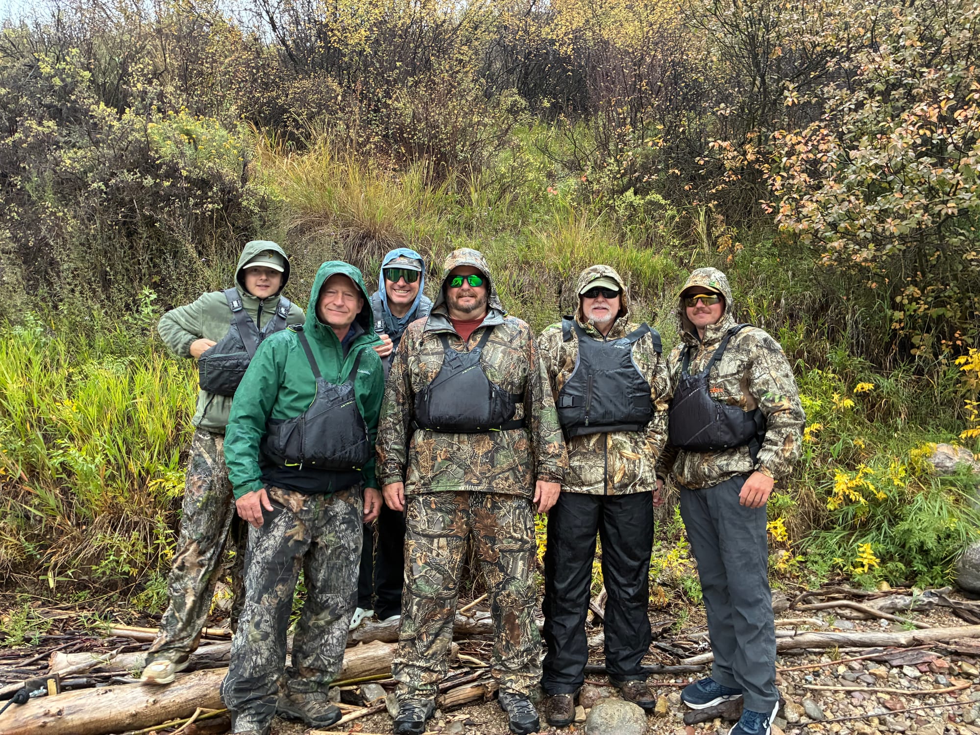 Picture of six fisherman on the bank of a river in Wyoming.