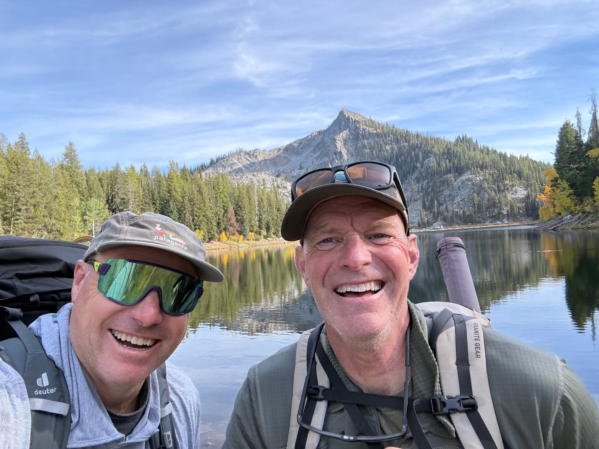 Picture of two guys in front of a mountain lake. 