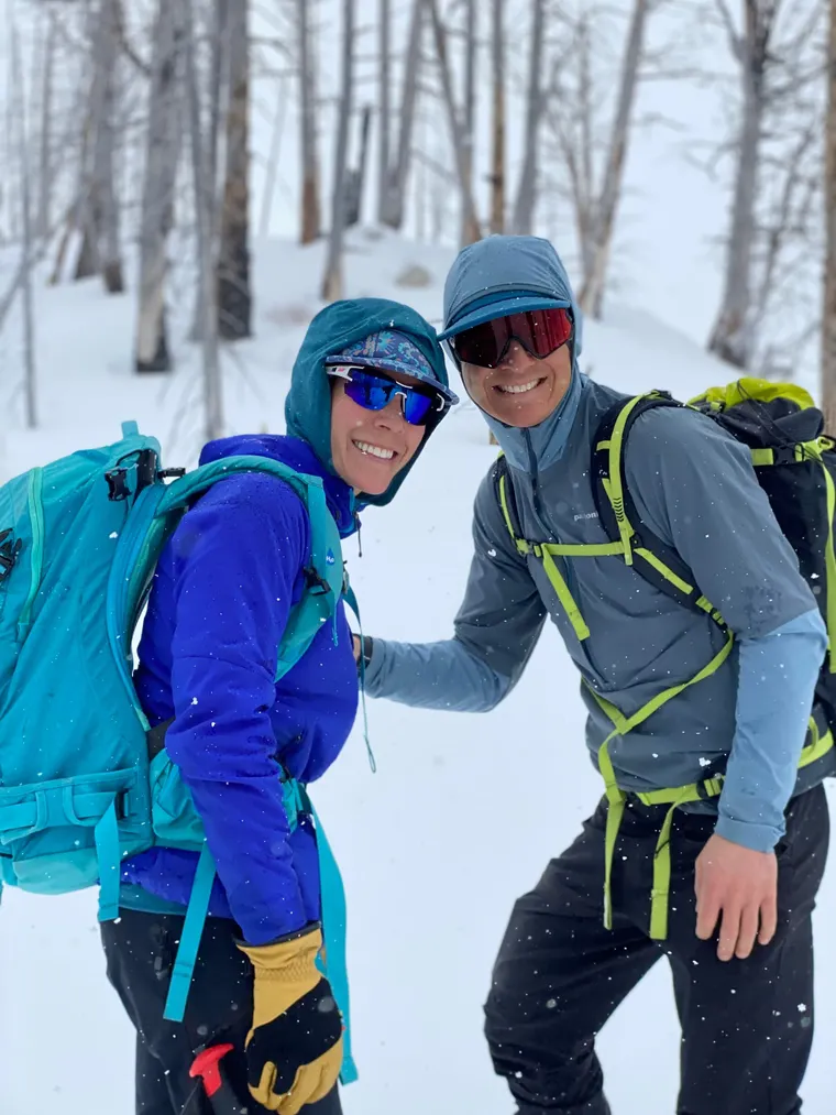 Picture of man and woman hiking through snow. 
