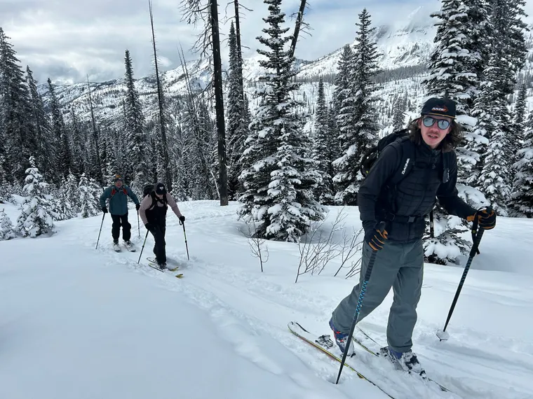 Picture of three backcountry skiers in the woods.