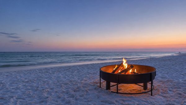 Permitted beach fire pit in an approved metal container on South Walton sand at dusk