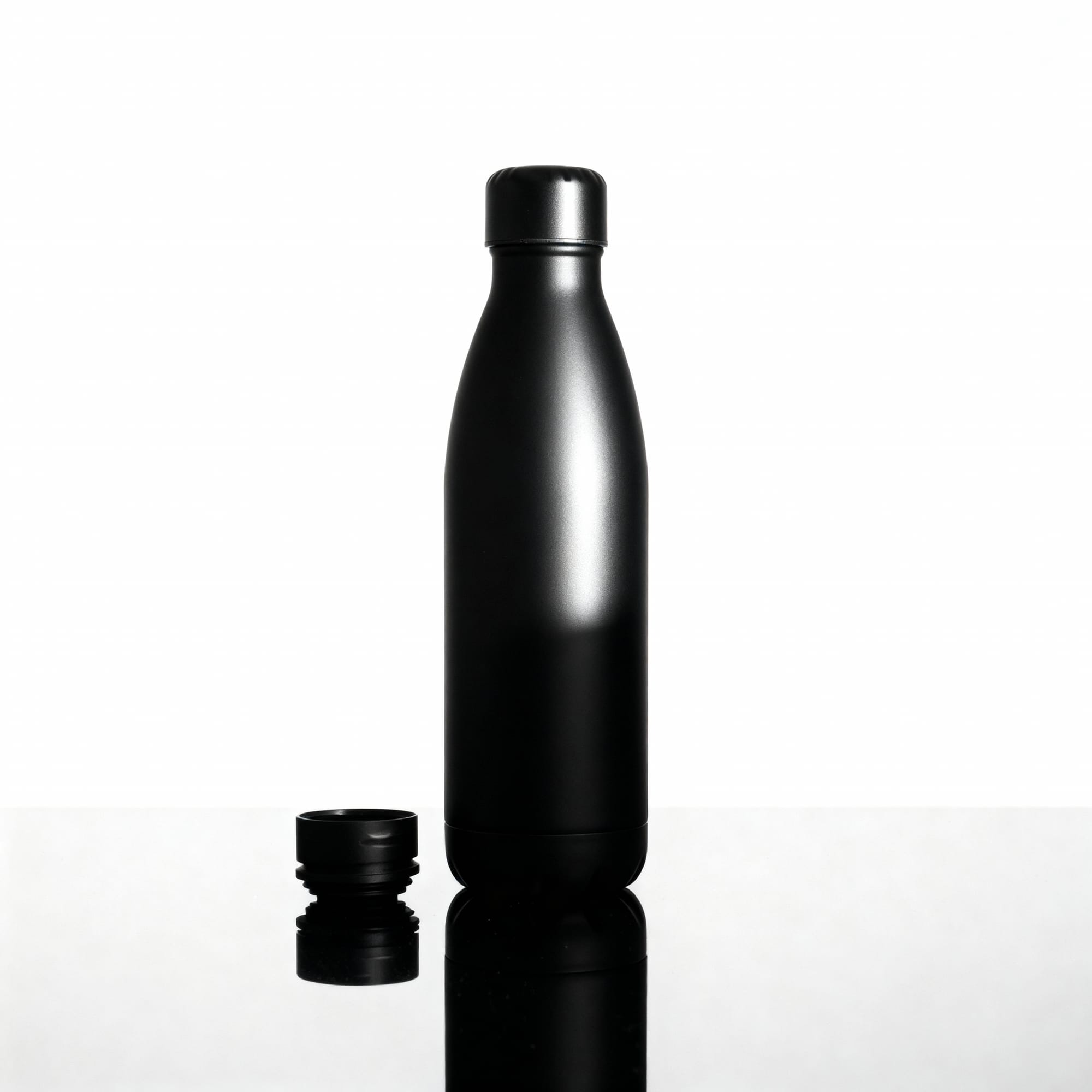 Sora AI-generated product shot featuring a matte-black stainless steel bottle on a reflective surface with studio lighting.