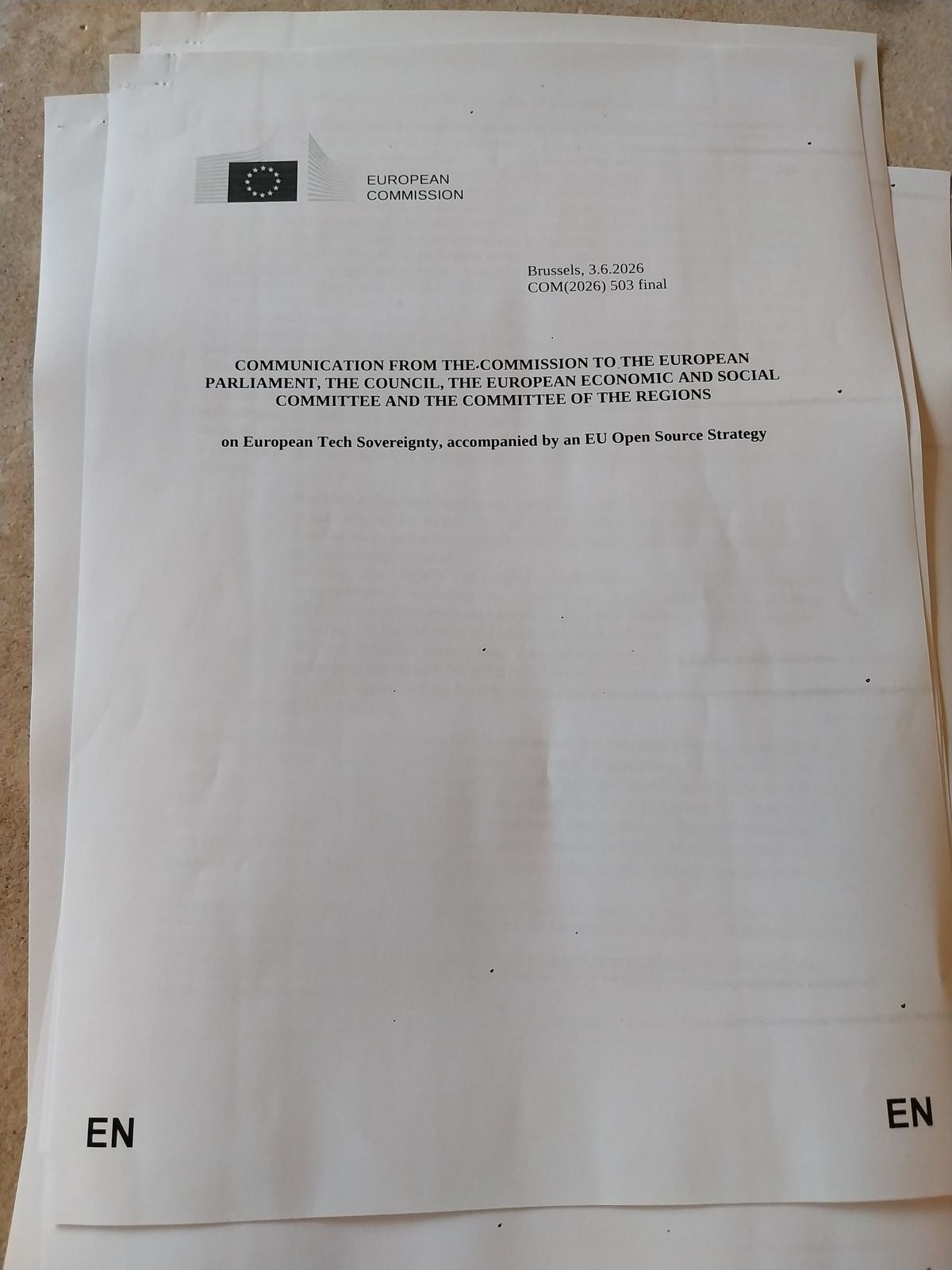 Photo of a stack of paper with a European Commission logo in the top-left corner and a very long title.