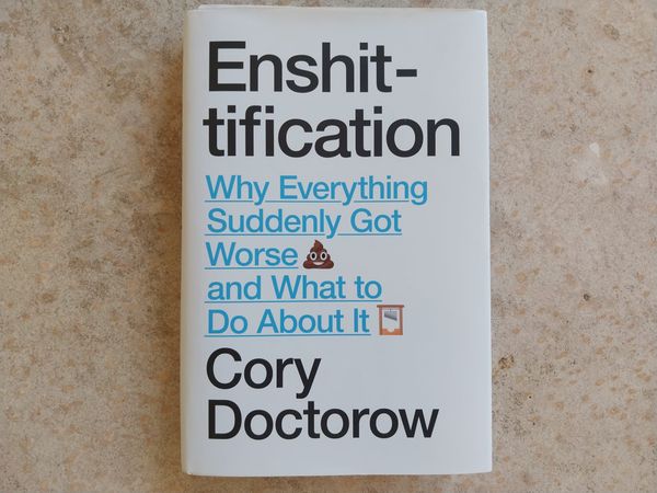 A book, seen against a concrete floor. The book is Enshittificantion by Cory Doctorow. The subtitle is "Why Everything Suddenly Got Worse and What to Do About It"