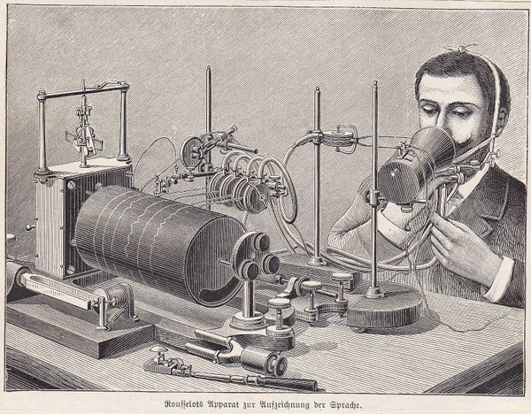 Woodcut illustration of a man speaking into an old-fashioned microphone which is connected up to a mechanical needle recording sound waves on a drum.