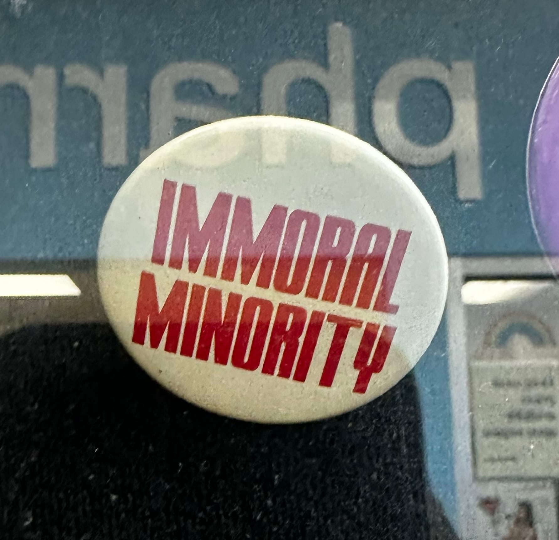 A pin reading "Immoral Minority"