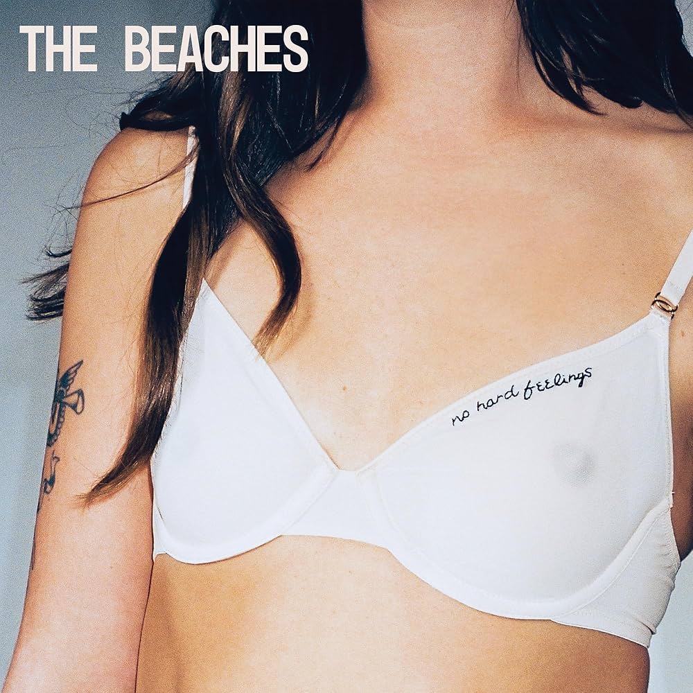The cover of The Beaches' "No Hard Feelings" depicting a woman's shirtless torso with the title written on her bra