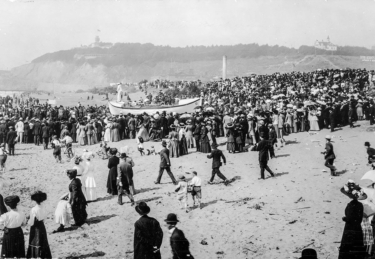 Ocean Beach with large crowd watching life-savers