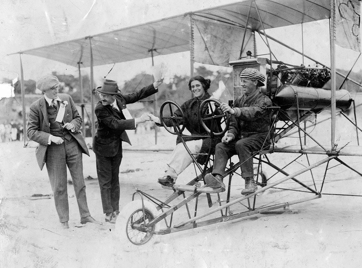 Harry Christofferson escorting Nell Schmidt up the beach for a swim on July 26, 1914.