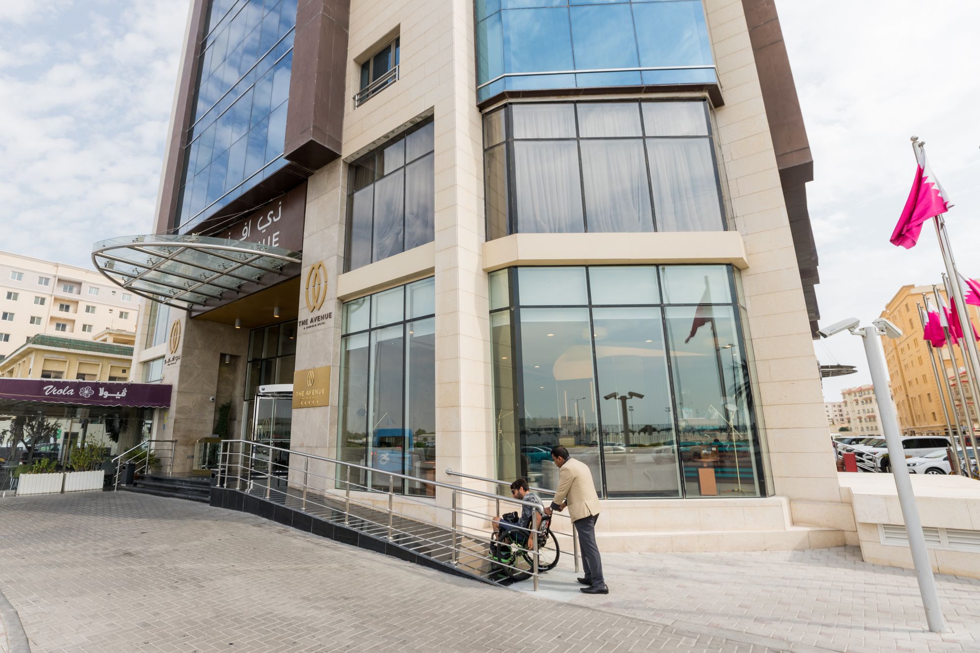 Wheelchair user accessing building via ramp 