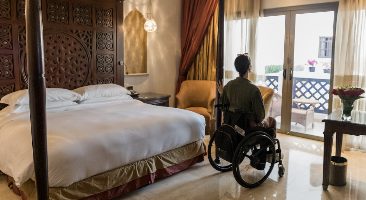 Wheelchair user in an accessible hotel room