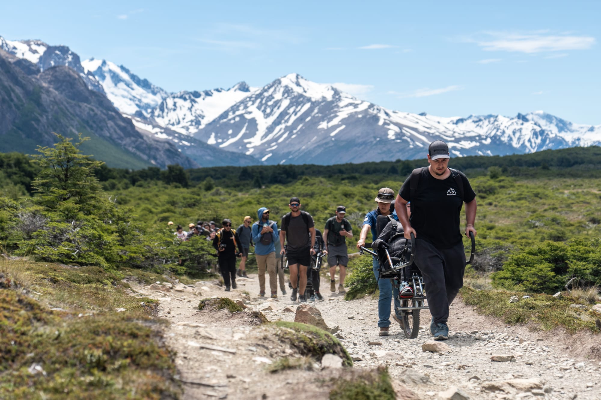 Hiking a trail of El Chaltén, Patagonia in a wheelchair with assistance.