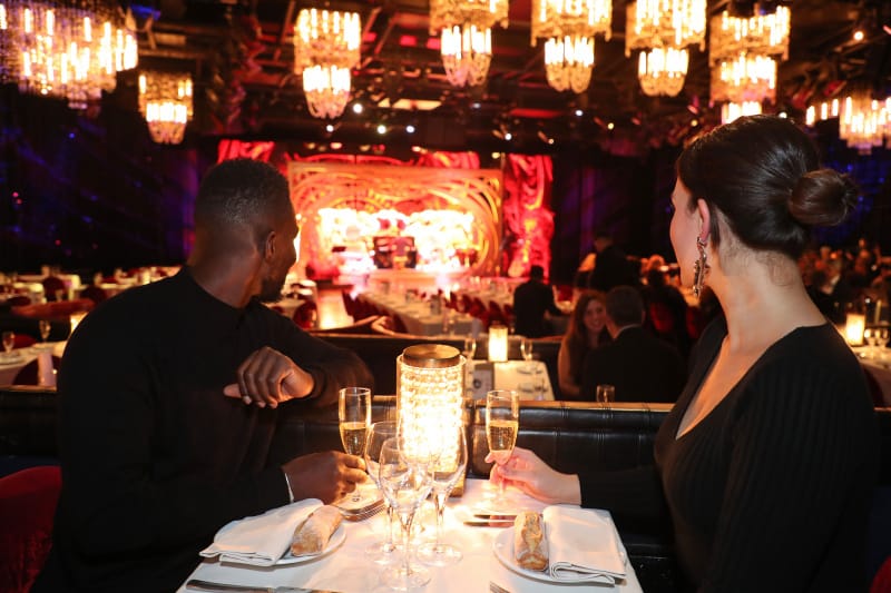 Couple enjoying dinner, drinks, and a show at Paris Lido