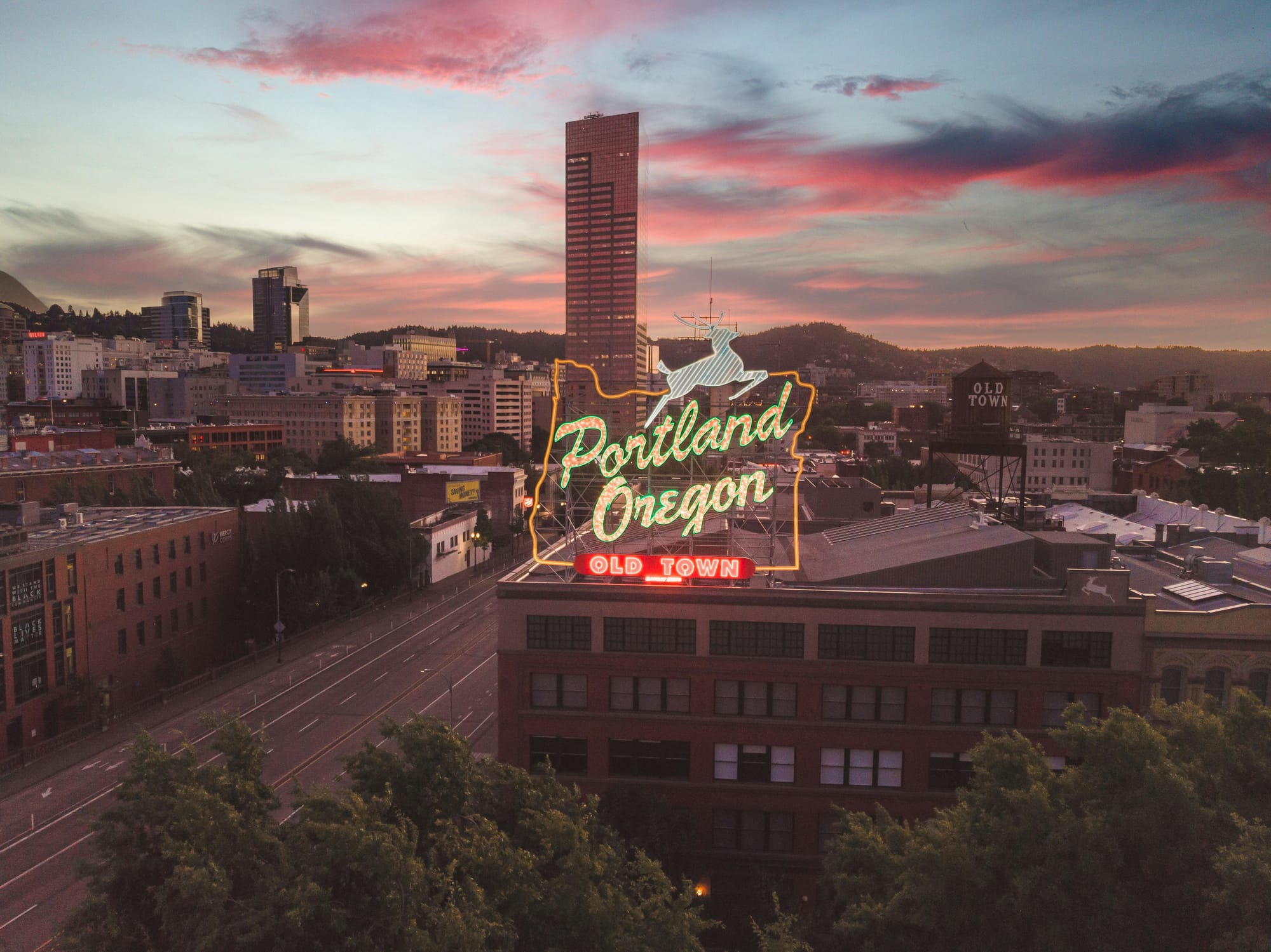A neon sign saying Portland Oregon Old Town