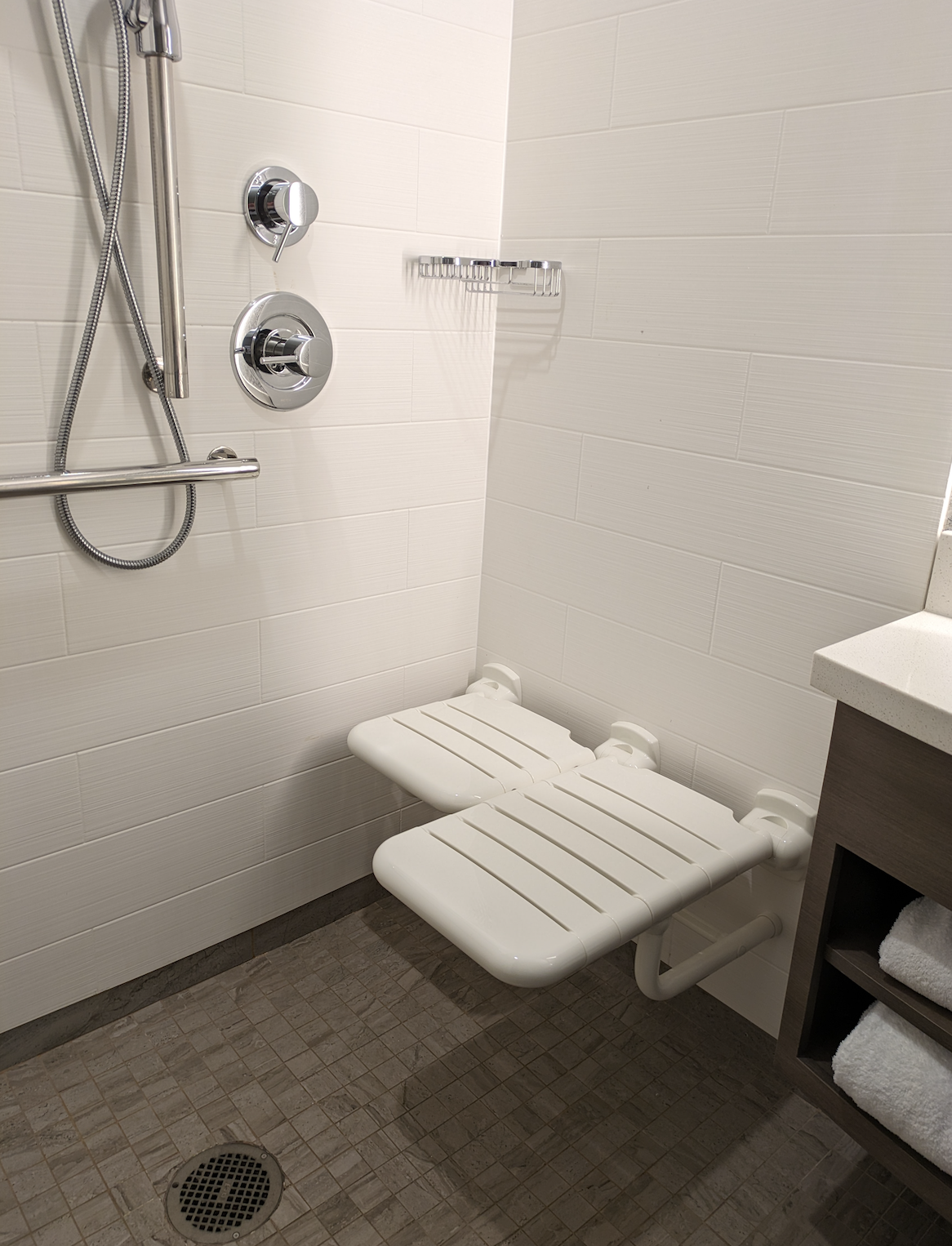 Roll-in shower with a seat and grab bars