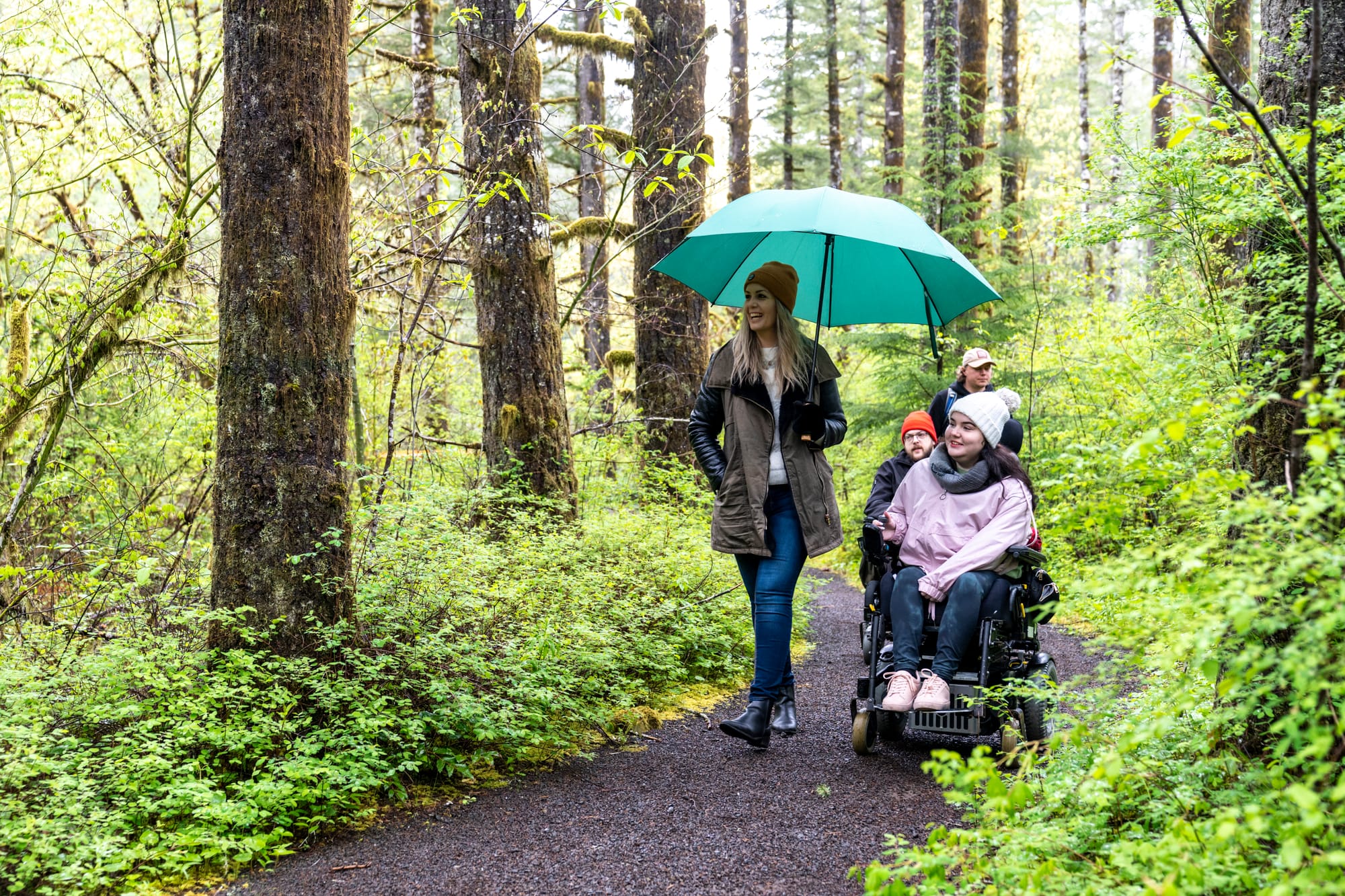 Wheelchair user and companion exploring accessible trails at Tillamook Forest Center