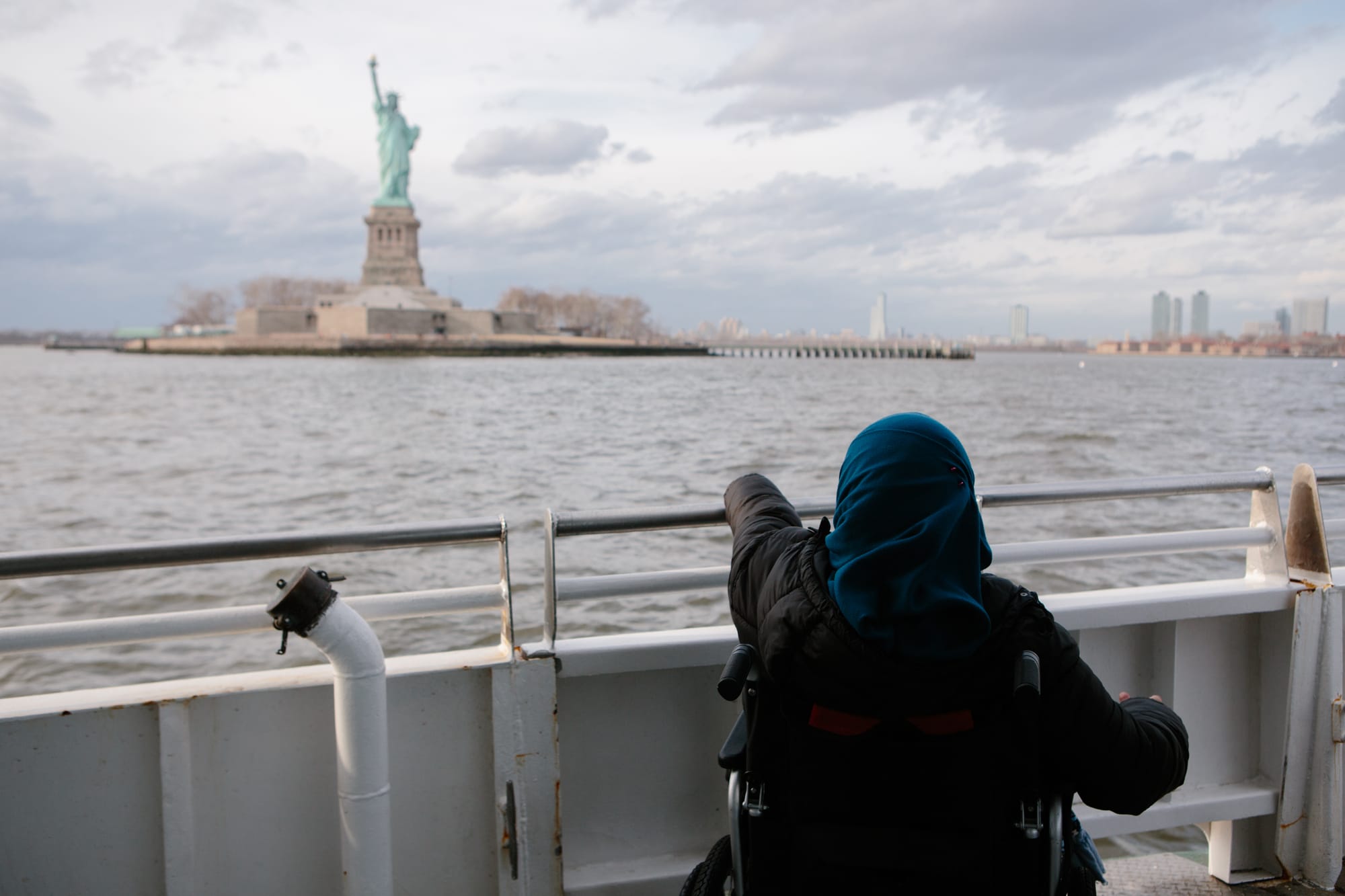 Wheelchair-use admiring the Statue of Liberty from the accessible boat