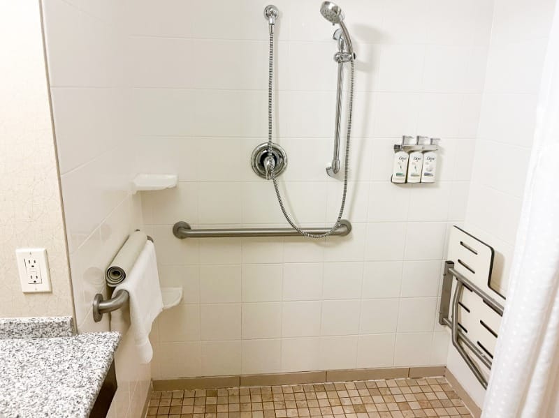 Roll-in shower, grab bars, and shower seat at Holiday Inn Express at First & Main in Colorado Springs