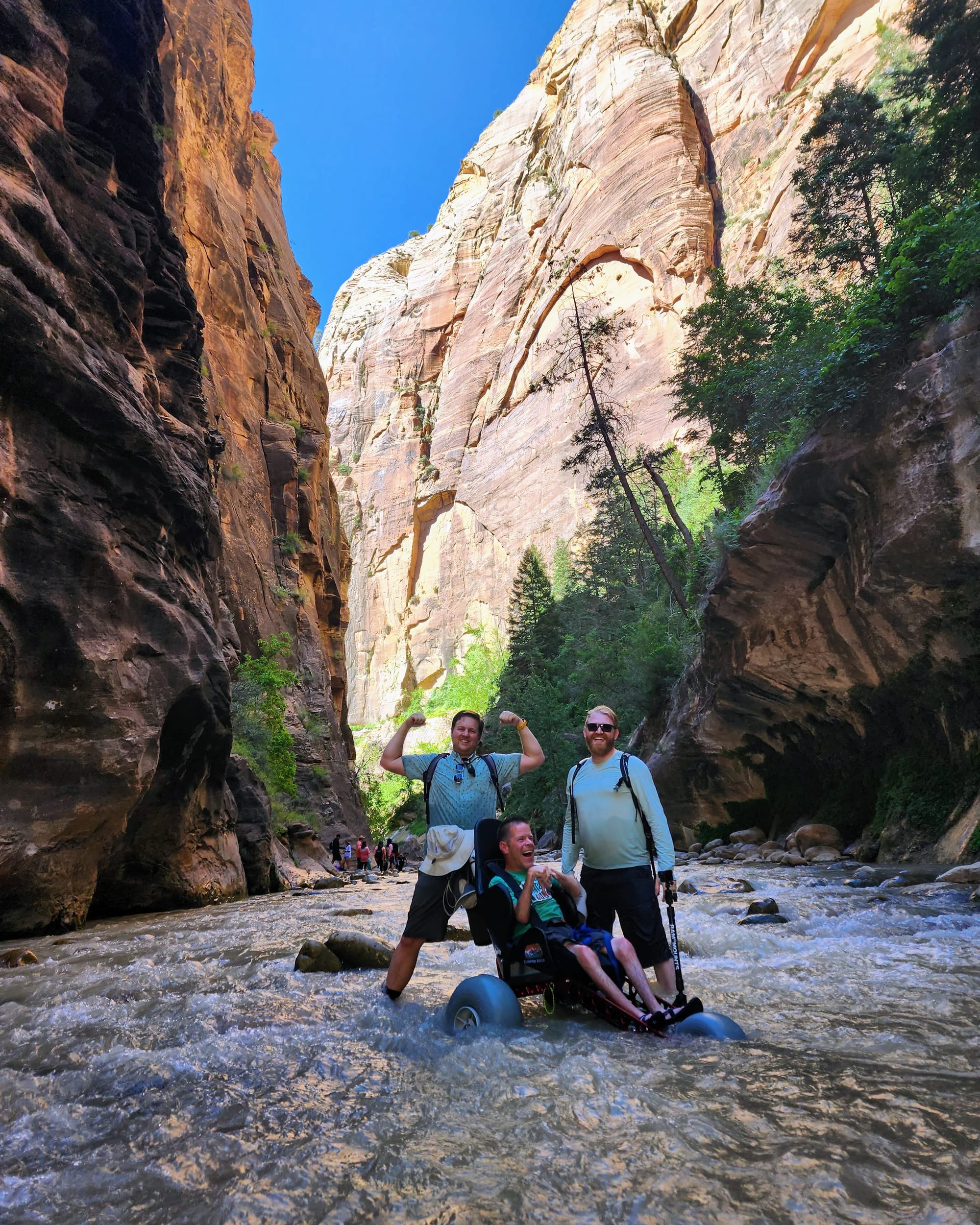 Wheelchair user and friends hiking The Narrows in Zion