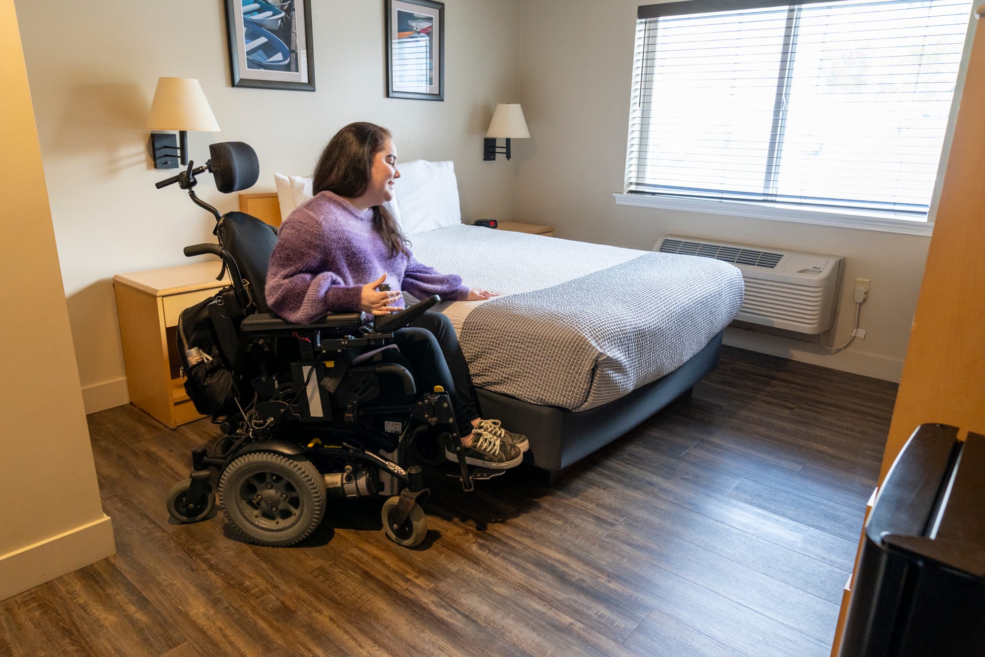 Power wheelchair user with a perfect bed height