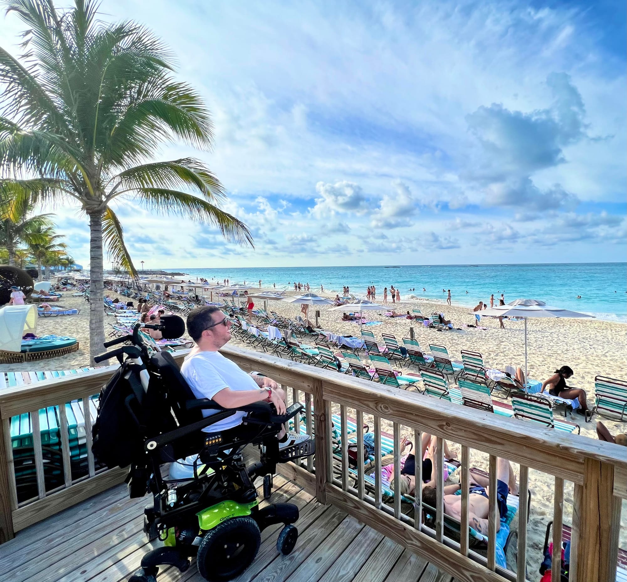 Cory Lee on an accessible boardwalk on a Virgin Voyages cruise stop
