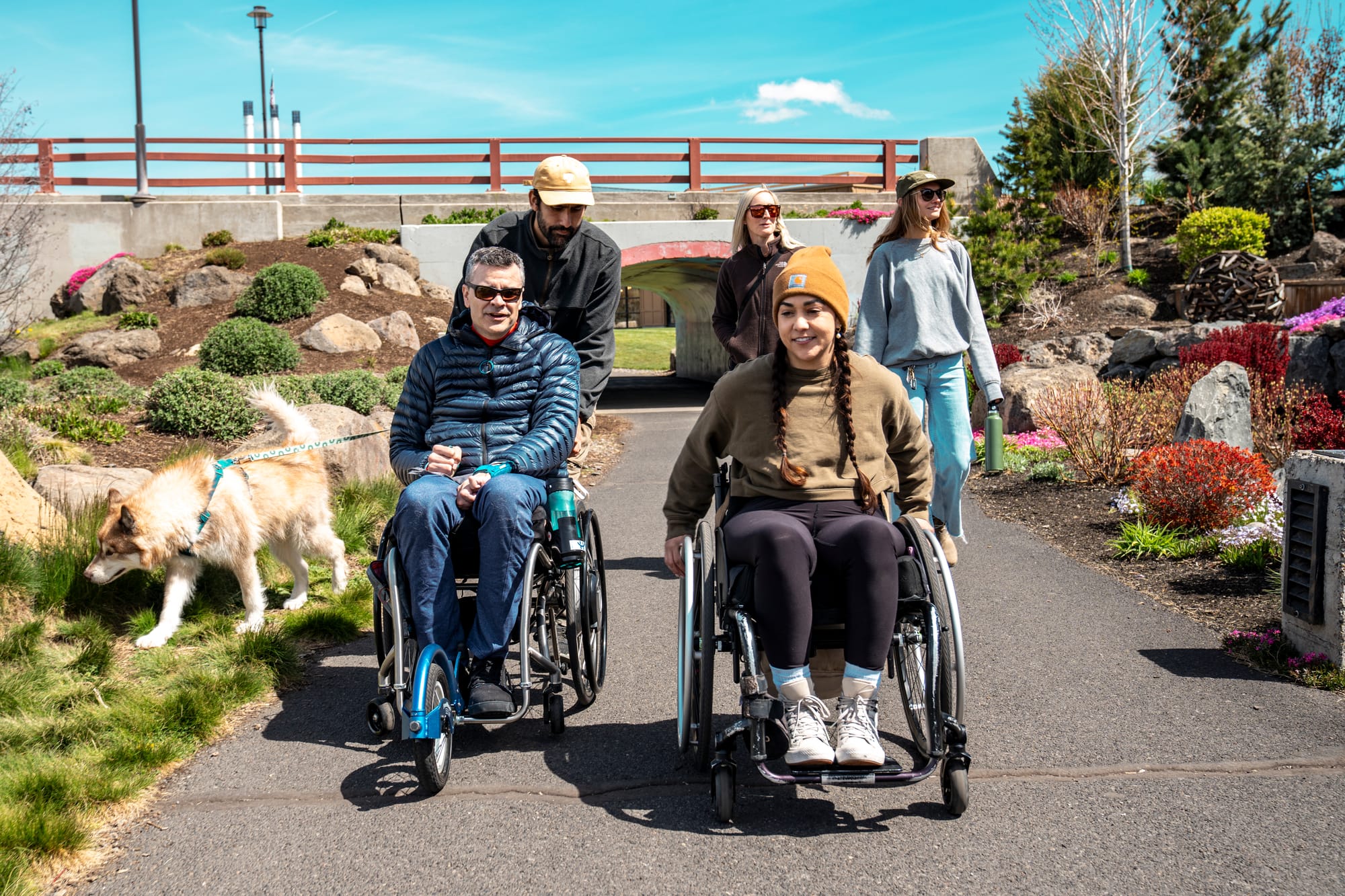 Two wheelchair users and companions traveling Bend, Oregon