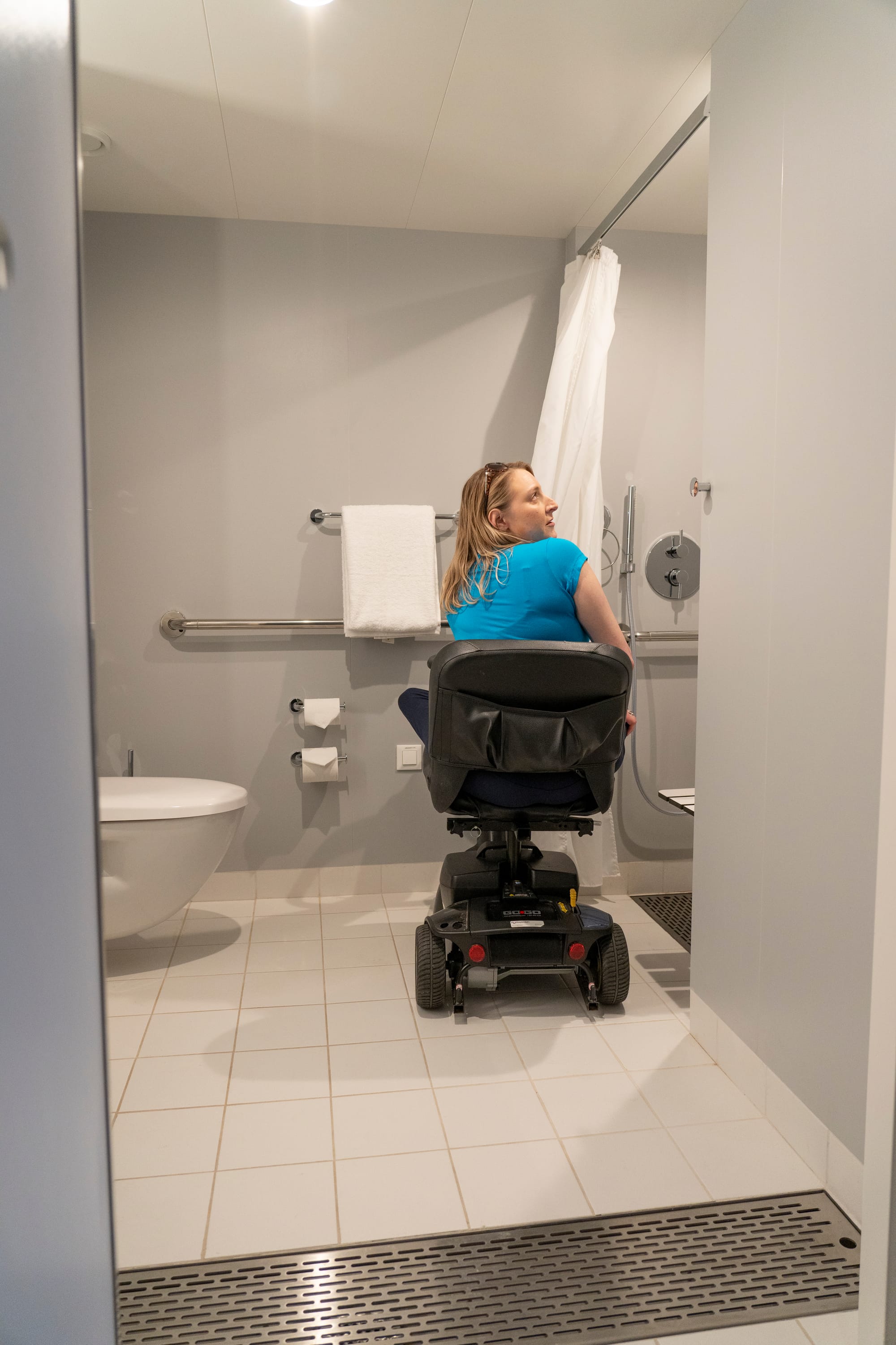 Wheelchair user exploring her accessible room onboard Virgin Voyages cruise