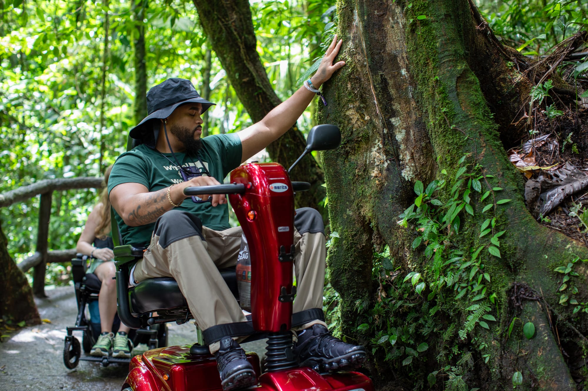 Wheelchair user feeling the trees and nature in Costa Rica