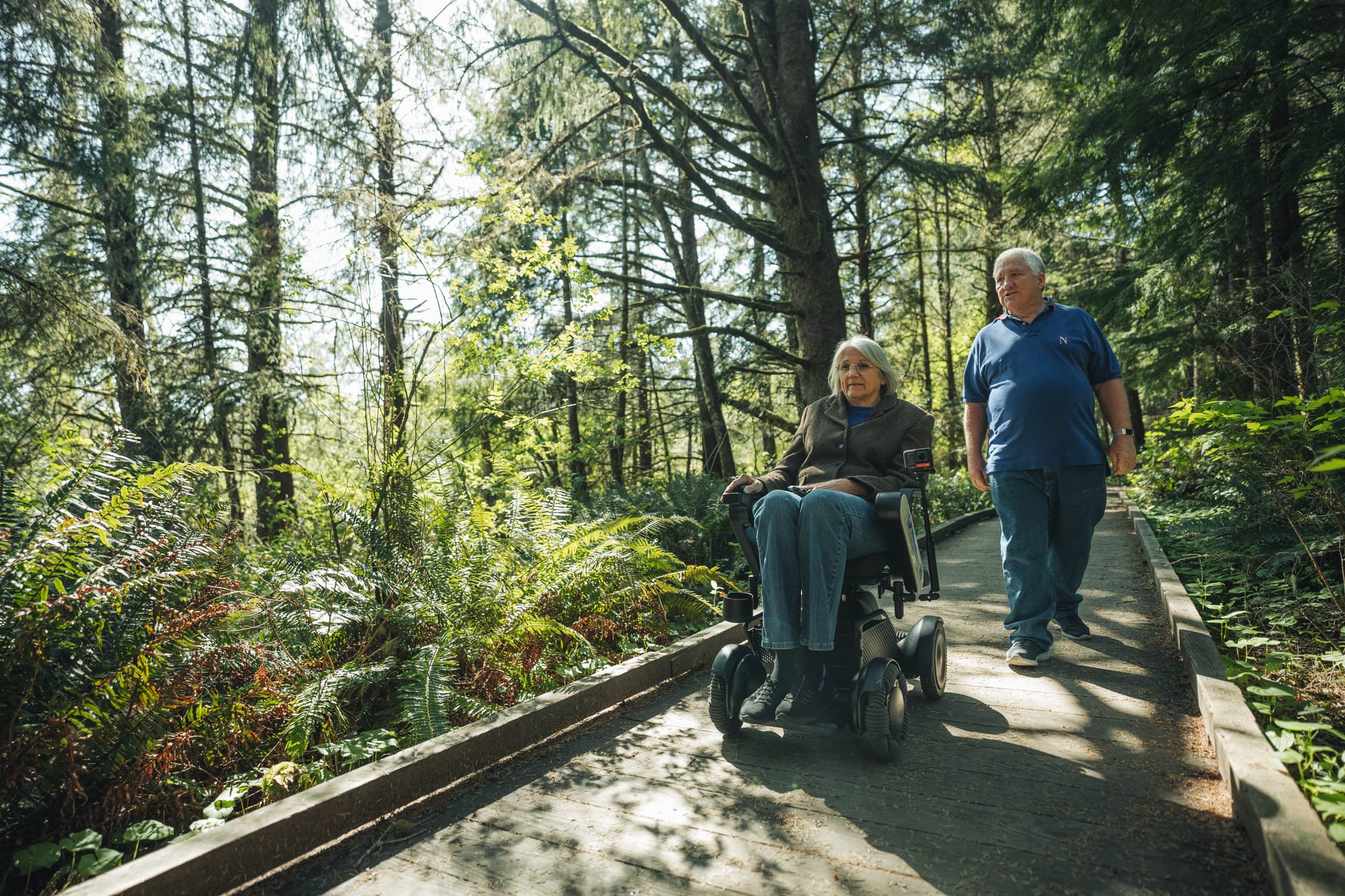 Wheelchair user and companion exploring accessible trails in Oregon