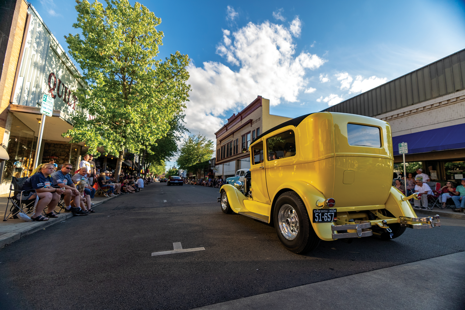 Yellow vehicle and observers at Graffiti Weekend event