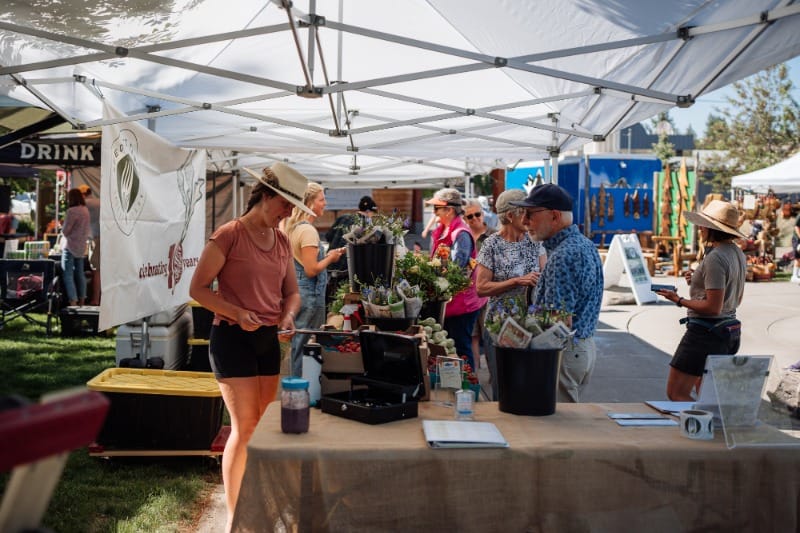 Vendor selling produce at Sisters Farmers Market