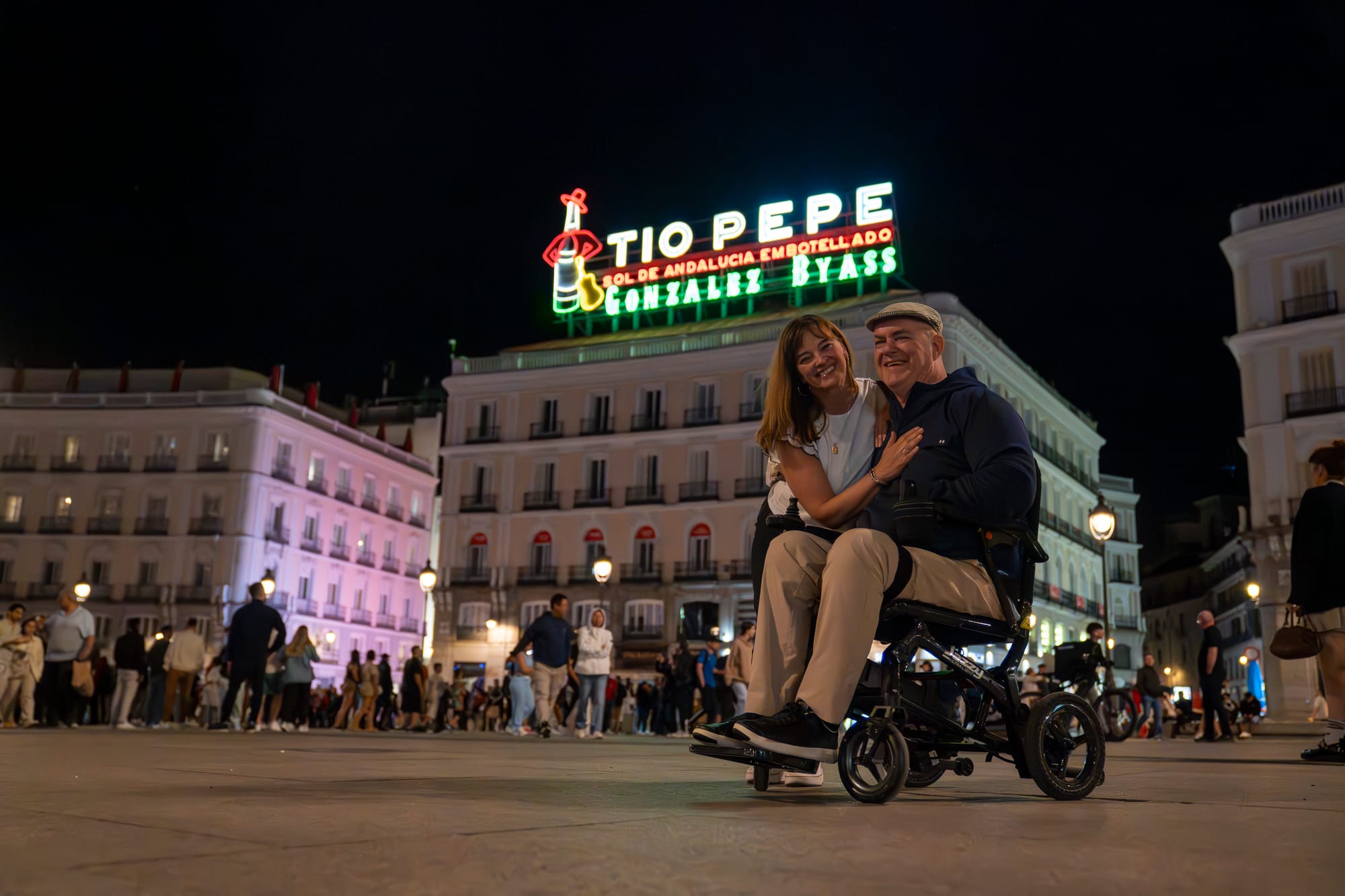 Wheelchair user and companion at Tio Pepe sign in Madrid
