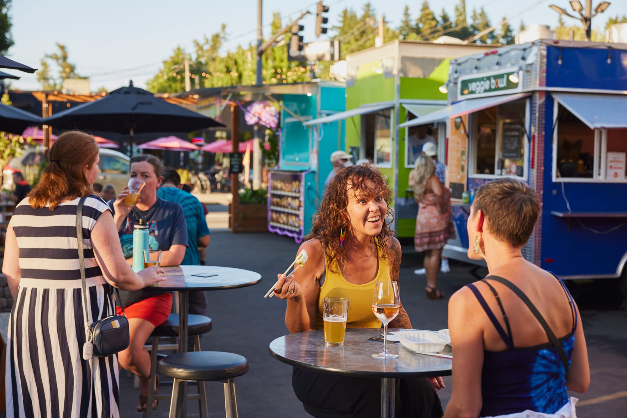 Friends enjoying food and drinks at Corner 14 Foodcarts